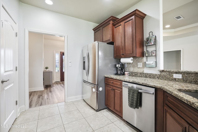 13111 Hawthorn Dr, Biloxi, MS 39532 - kitchen featuring stainless steel appliances, backsplash, light stone countertops, recessed lighting, and light tile patterned floors
