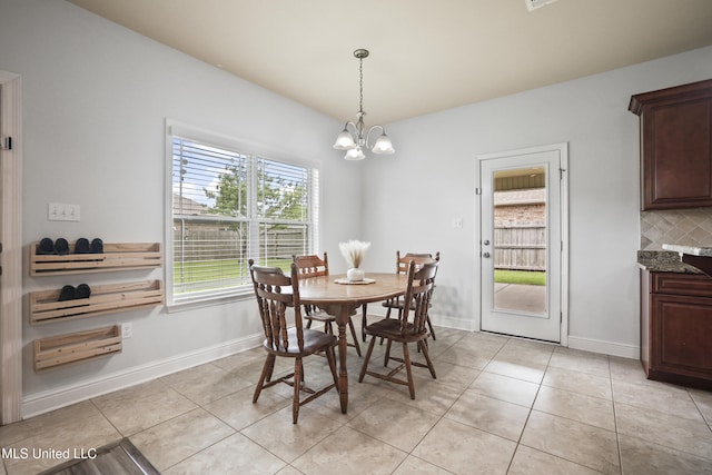 13111 Hawthorn Dr, Biloxi, MS 39532 - dining room with a chandelier, light tile patterned floors, and baseboards