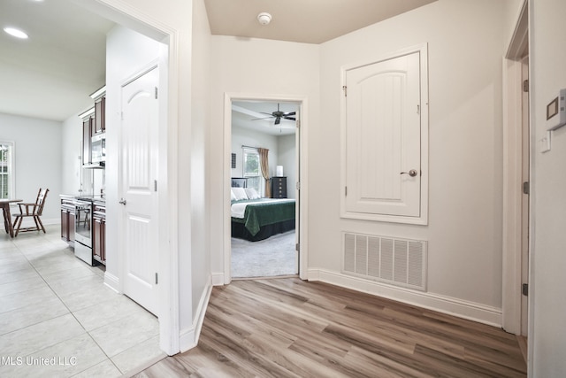 13111 Hawthorn Dr, Biloxi, MS 39532 - hallway with baseboards, light wood-style floors, and recessed lighting