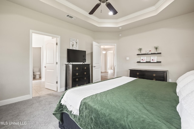 13111 Hawthorn Dr, Biloxi, MS 39532 - bedroom with crown molding, a raised ceiling, light colored carpet, baseboards, and connected bathroom