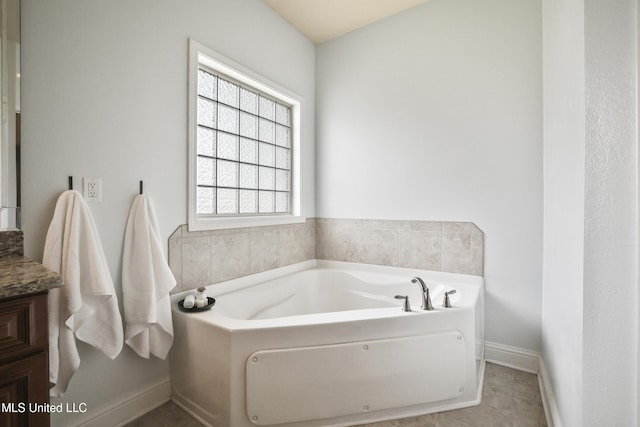 13111 Hawthorn Dr, Biloxi, MS 39532 - bathroom featuring a bath, vanity, and baseboards