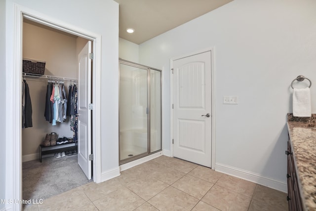 13111 Hawthorn Dr, Biloxi, MS 39532 - full bath featuring a shower stall, vanity, a walk in closet, baseboards, and recessed lighting