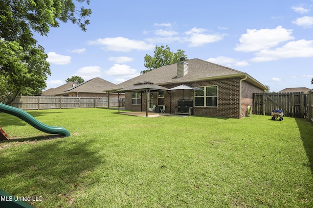 13111 Hawthorn Dr, Biloxi, MS 39532 - back of house featuring a gazebo, brick siding, a patio, a chimney, and a playground
