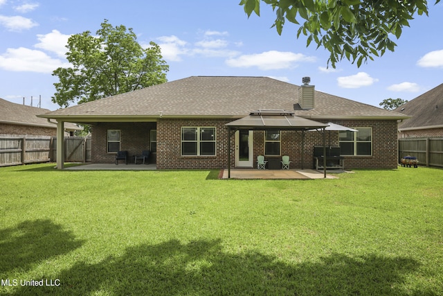 13111 Hawthorn Dr, Biloxi, MS 39532 - rear view of house with a gazebo, a patio area, roof with shingles, and a chimney