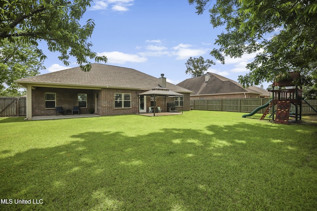 13111 Hawthorn Dr, Biloxi, MS 39532 - rear view of house featuring a gazebo, a playground, a patio area, brick siding, and a chimney