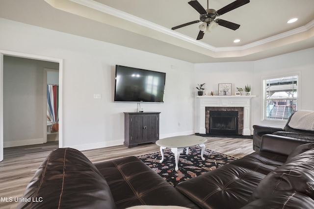 13111 Hawthorn Dr, Biloxi, MS 39532 - living area with a tray ceiling, wood finished floors, crown molding, ceiling fan, and baseboards