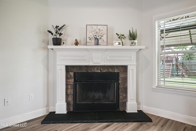 13111 Hawthorn Dr, Biloxi, MS 39532 - detailed view of wood finished floors, a fireplace, and baseboards
