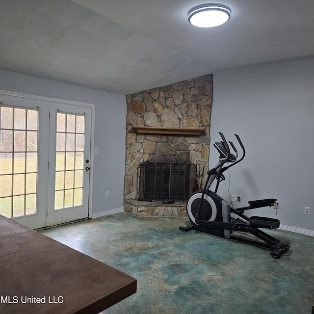 exercise area with carpet flooring and a stone fireplace