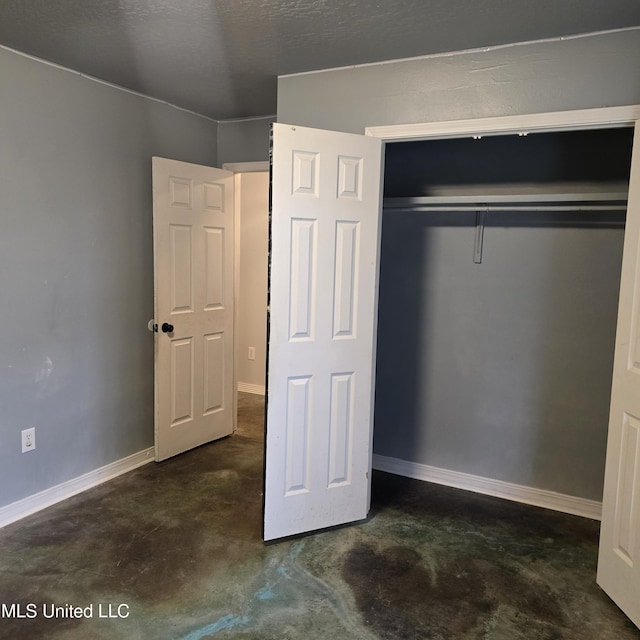 unfurnished bedroom featuring a closet and a textured ceiling