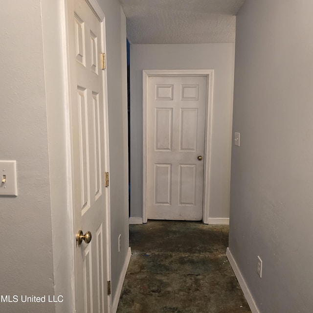hallway featuring a textured ceiling