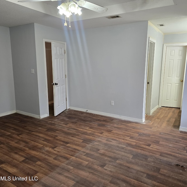 spare room featuring dark hardwood / wood-style floors and ceiling fan