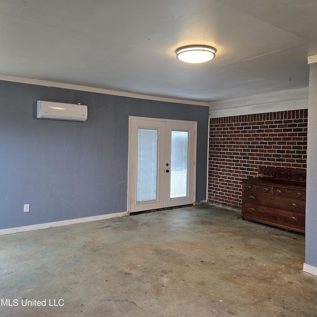 spare room with brick wall, a wall mounted air conditioner, concrete floors, ornamental molding, and french doors