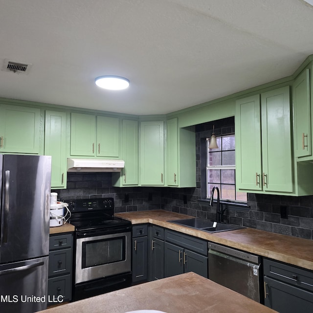 kitchen featuring backsplash, green cabinets, sink, and black appliances