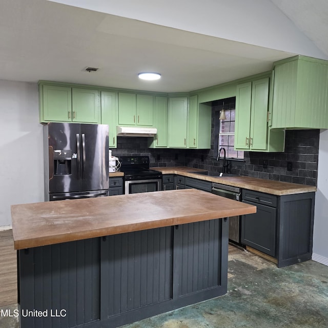 kitchen with wood counters, sink, green cabinets, and appliances with stainless steel finishes