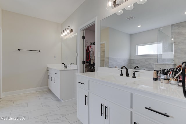 bathroom with vanity and a tile shower