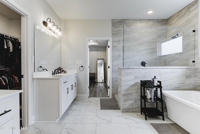 bathroom with vanity, independent shower and bath, and tile walls