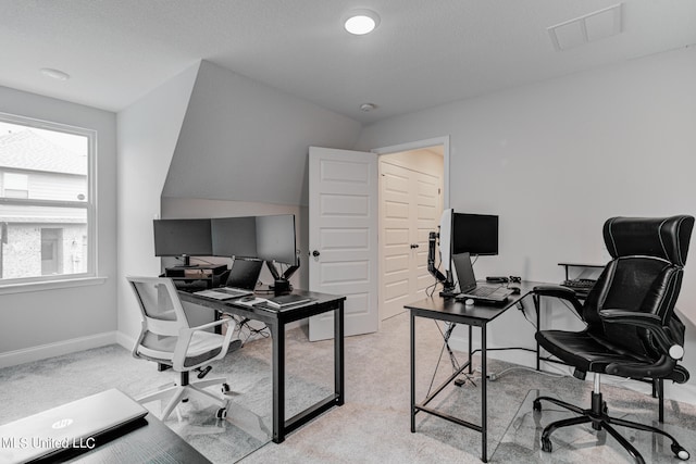 office featuring light carpet, a textured ceiling, and vaulted ceiling