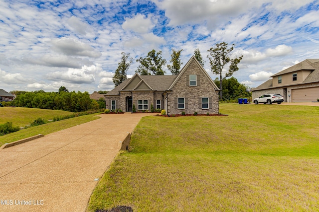 view of front of home with a front lawn and a garage