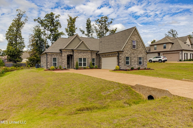 view of front facade with a garage and a front lawn