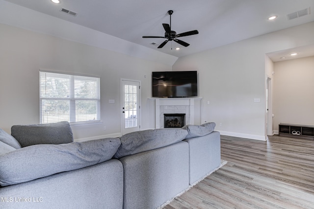 living room with lofted ceiling, wood-type flooring, and ceiling fan