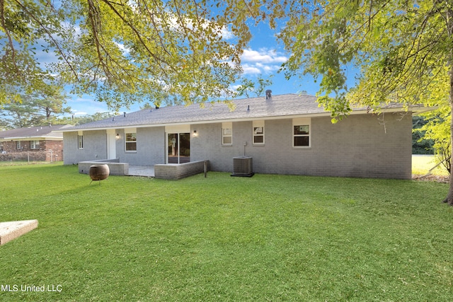 rear view of house with a patio area and a lawn