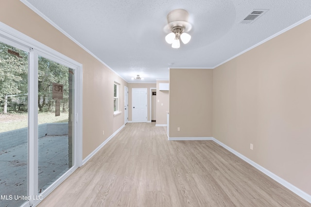 hall featuring light hardwood / wood-style floors, ornamental molding, and a textured ceiling