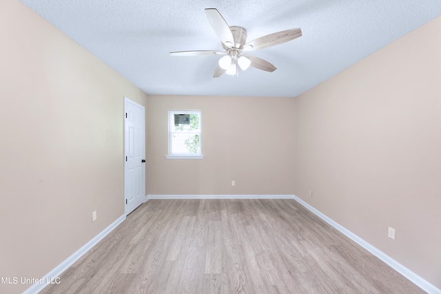 unfurnished room with ceiling fan, a textured ceiling, and light wood-type flooring