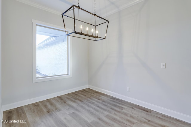 unfurnished dining area with a wealth of natural light, ornamental molding, and light hardwood / wood-style floors