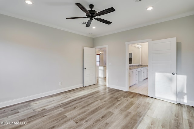 unfurnished bedroom with crown molding, ensuite bathroom, and light wood-type flooring