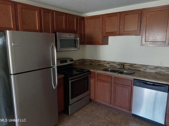 502 Dorsett Dr, Indianola, MS 38751 - kitchen with sink, light stone counters, stainless steel appliances, and light tile patterned floors