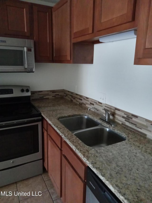 502 Dorsett Dr, Indianola, MS 38751 - kitchen featuring appliances with stainless steel finishes, sink, light stone counters, decorative backsplash, and light tile patterned floors