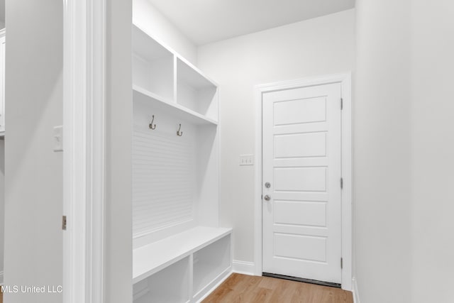 mudroom with baseboards and light wood-style flooring
