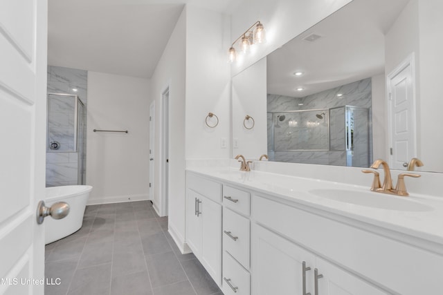 bathroom with a marble finish shower, double vanity, and a sink