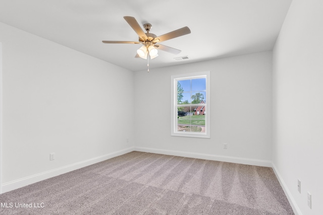 spare room with visible vents, ceiling fan, baseboards, and carpet floors