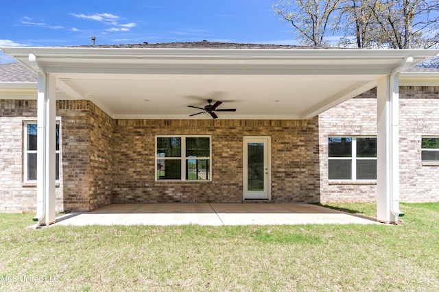 rear view of house featuring a yard, ceiling fan, and a patio area