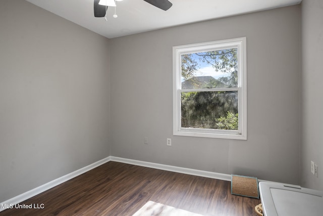 spare room featuring ceiling fan and dark hardwood / wood-style flooring