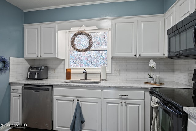 kitchen featuring sink, tasteful backsplash, white cabinetry, and black appliances