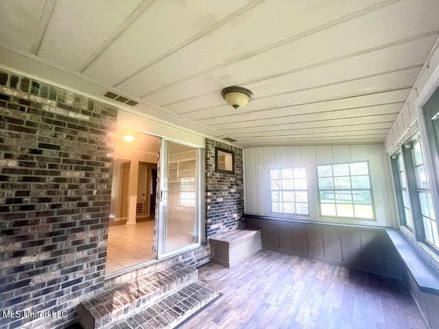 unfurnished sunroom featuring lofted ceiling