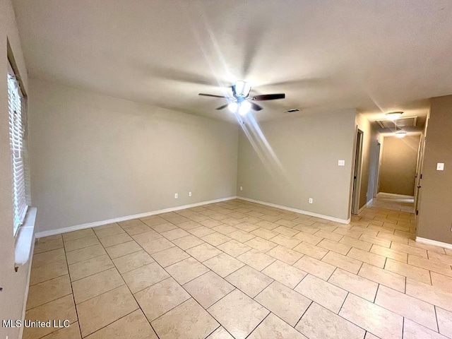 spare room featuring ceiling fan and light tile patterned flooring