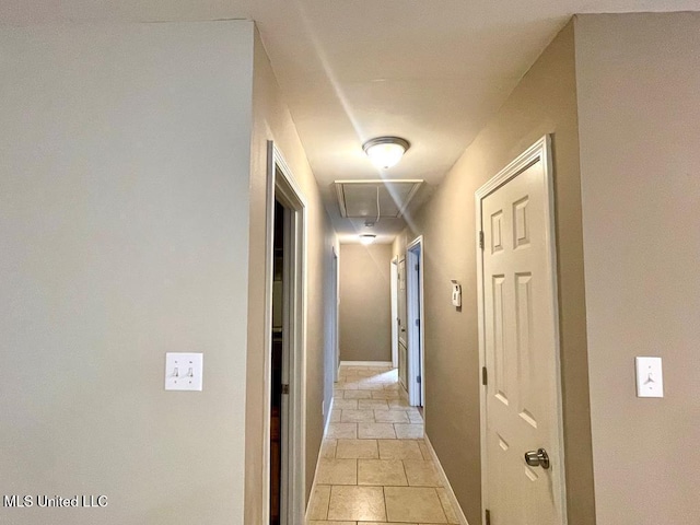 corridor with light tile patterned flooring