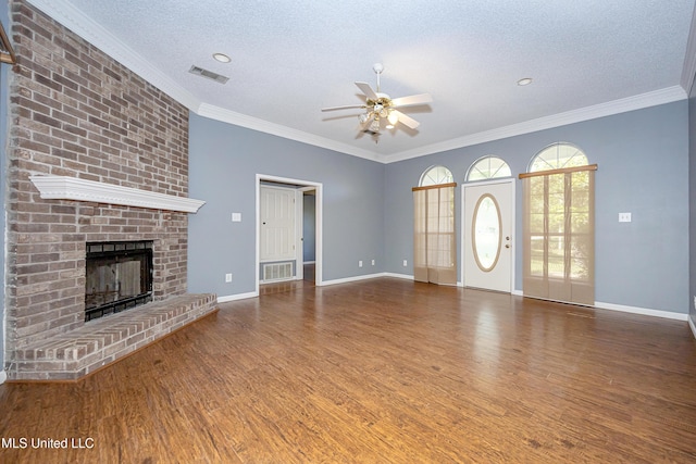 8113 Barron Rd, Moss Point, MS 39562 - unfurnished living room featuring ceiling fan, wood finished floors, a textured ceiling, a fireplace, and baseboards
