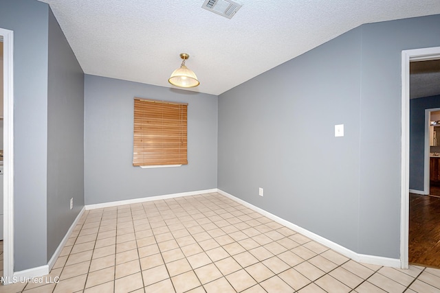 8113 Barron Rd, Moss Point, MS 39562 - empty room featuring a textured ceiling, baseboards, and light tile patterned floors