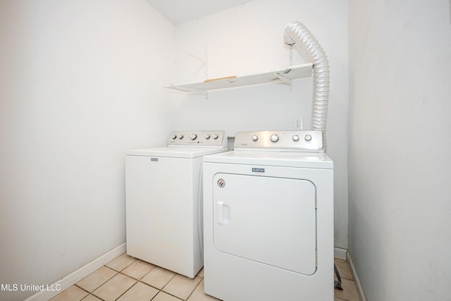 8113 Barron Rd, Moss Point, MS 39562 - laundry area with washing machine and clothes dryer, baseboards, and light tile patterned floors