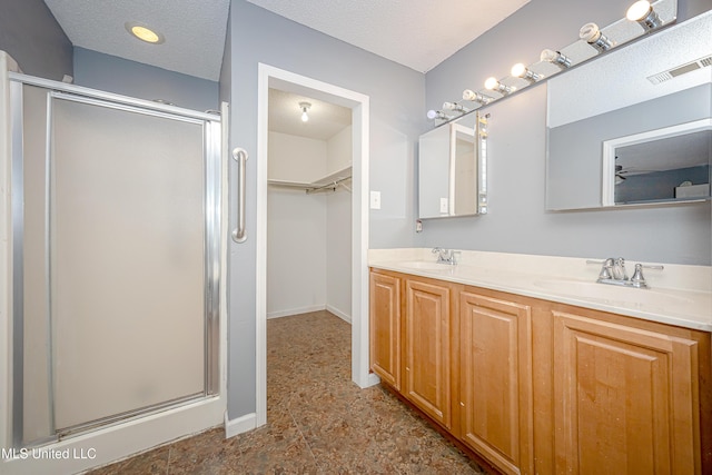 8113 Barron Rd, Moss Point, MS 39562 - bathroom with a shower stall, a spacious closet, double vanity, and baseboards