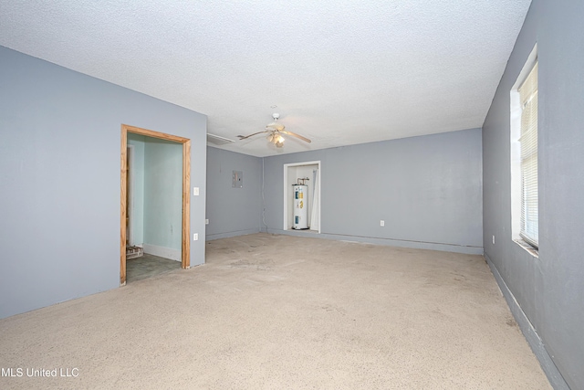 8113 Barron Rd, Moss Point, MS 39562 - spare room with water heater, a textured ceiling, a ceiling fan, and baseboards