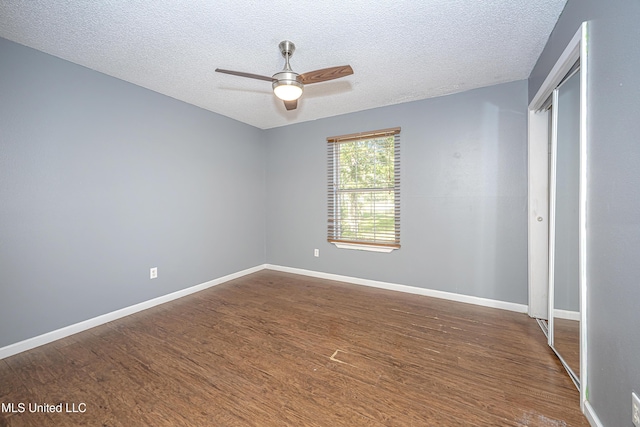 8113 Barron Rd, Moss Point, MS 39562 - unfurnished bedroom with dark wood-type flooring, a textured ceiling, and baseboards