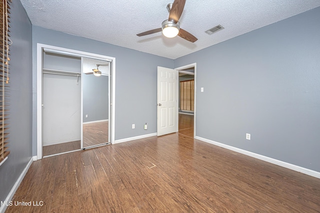8113 Barron Rd, Moss Point, MS 39562 - unfurnished bedroom with wood finished floors, a closet, baseboards, a textured ceiling, and ceiling fan