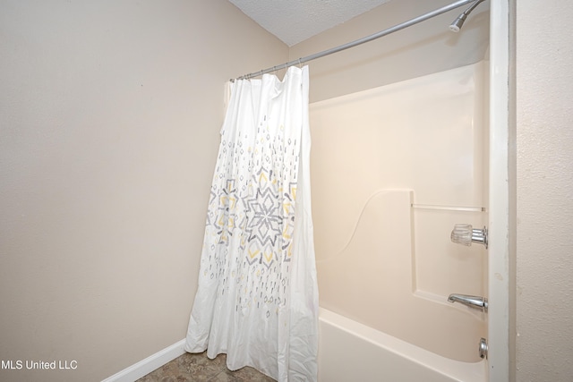 8113 Barron Rd, Moss Point, MS 39562 - bathroom with shower / tub combo, a textured ceiling, and baseboards