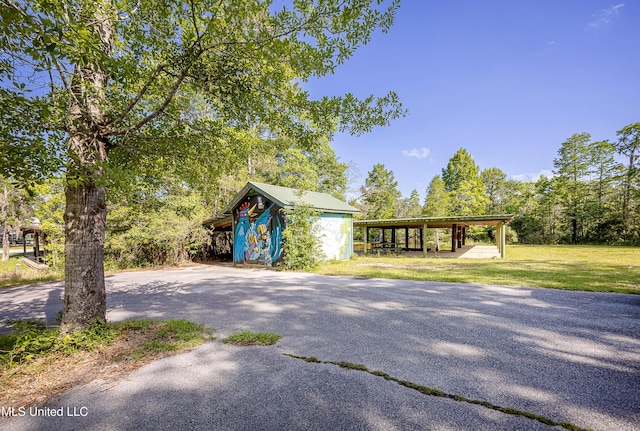 8113 Barron Rd, Moss Point, MS 39562 - view of front of property featuring a front lawn, driveway, and metal roof