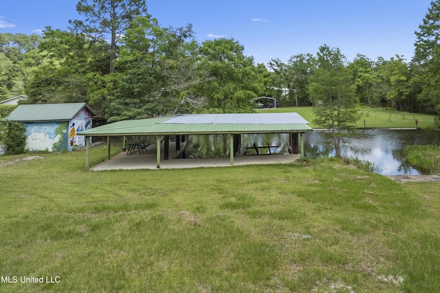 8113 Barron Rd, Moss Point, MS 39562 - exterior space with a water view, a yard, a detached carport, and a patio